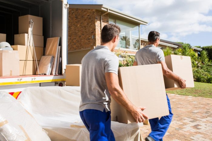movers moving boxes into home